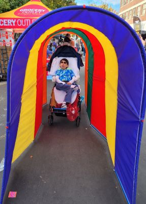 Little diverse girls decorating pumpkin with paint